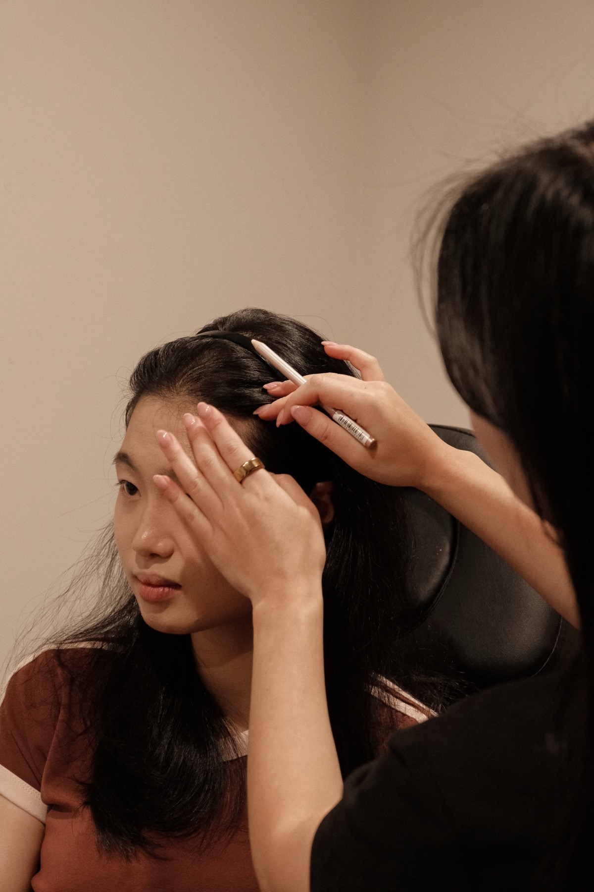 Crystal performing a scalp treatment in the studio